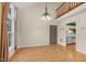 Open floor plan showing living room with hardwood floors, chandelier, and view to the kitchen at 4117 Olde Coach Rd, Durham, NC 27707