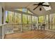 Covered porch with a ceiling fan and outdoor seating with a view of the woods at 4117 Olde Coach Rd, Durham, NC 27707