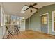 Relaxing covered porch featuring a fan, skylight, seating and wooded backyard views at 4117 Olde Coach Rd, Durham, NC 27707