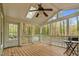 Screened-in porch featuring skylight, ceiling fan, and views of lush, mature trees at 4117 Olde Coach Rd, Durham, NC 27707