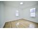 Bright bedroom featuring hardwood floors and natural light from two windows at 423 E Rockspring St, Henderson, NC 27536
