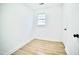 Clean and bright bedroom with a window, closet and wood-look flooring at 423 E Rockspring St, Henderson, NC 27536