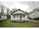 Charming white bungalow with a cozy front porch and a well-maintained lawn at 423 E Rockspring St, Henderson, NC 27536