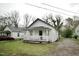 Cozy white bungalow with welcoming front porch and gravel driveway at 423 E Rockspring St, Henderson, NC 27536