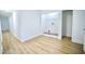 Hallway with wood-look flooring leading to a laundry area at 423 E Rockspring St, Henderson, NC 27536