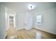 Bright living room with new hardwood flooring and a large window at 423 E Rockspring St, Henderson, NC 27536