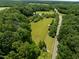 An aerial view highlighting the vast, open fields and greenery of the expansive property at 4811 New Sharon Church Rd, Hillsborough, NC 27278