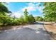 Long driveway leading to a home with lush greenery and mature trees on either side at 4811 New Sharon Church Rd, Hillsborough, NC 27278