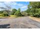 Long driveway leading to a home with lush greenery and mature trees on either side at 4811 New Sharon Church Rd, Hillsborough, NC 27278