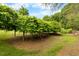 The exterior is lined with a long leafy hedge at 4811 New Sharon Church Rd, Hillsborough, NC 27278