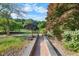 Landscaped path through lush yard with garden accents and colorful trees at 4811 New Sharon Church Rd, Hillsborough, NC 27278