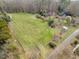 Aerial view of a sprawling property with a large field and mature trees at 4811 New Sharon Church Rd, Hillsborough, NC 27278