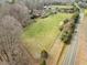 An aerial view showcasing this parcel's vast open land, mature trees and road frontage at 4811 New Sharon Church Rd, Hillsborough, NC 27278