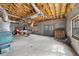 Unfinished basement with exposed ceiling, concrete floor, and windows for natural light at 4811 New Sharon Church Rd, Hillsborough, NC 27278