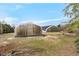 View of two large greenhouses on a spacious lawn under a blue sky at 4811 New Sharon Church Rd, Hillsborough, NC 27278