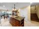 Open kitchen design with island seating, pendant lighting, and stylish tile floors at 4811 New Sharon Church Rd, Hillsborough, NC 27278