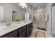 Bathroom featuring double sink vanity, framed mirror, and glass shower with neutral tile at 508 Sweet Pine Ln, Knightdale, NC 27545