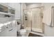 Bright bathroom featuring a glass shower stall, white cabinet storage, and stacked towels at 508 Sweet Pine Ln, Knightdale, NC 27545