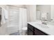 Bright bathroom with a shower-tub combo, white shower curtain, dark cabinet and undermount sink at 508 Sweet Pine Ln, Knightdale, NC 27545