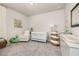 Bright Bedroom with a rocking chair, white crib, plush carpet, and decorative baskets at 508 Sweet Pine Ln, Knightdale, NC 27545