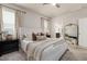 Comfortable bedroom with neutral tones, ceiling fan, plush carpet, and natural light at 508 Sweet Pine Ln, Knightdale, NC 27545
