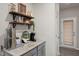 Counter with stainless steel appliances and dark wooden shelves with decorations and wine bottles at 508 Sweet Pine Ln, Knightdale, NC 27545