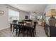 Dining area showcases a black table set, hardwood floors, and a view into the spacious living area at 508 Sweet Pine Ln, Knightdale, NC 27545