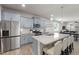 Modern kitchen boasts stainless appliances, light blue cabinets, quartz counters and an island with bar stool seating at 508 Sweet Pine Ln, Knightdale, NC 27545