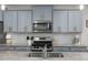 Modern kitchen features stainless steel appliances, granite countertops, and stylish blue cabinets at 508 Sweet Pine Ln, Knightdale, NC 27545