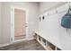Mudroom features a built-in bench with storage, hooks for hanging, and an exterior door at 508 Sweet Pine Ln, Knightdale, NC 27545