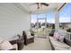 Relaxing screened porch with comfortable seating, string lights, and a view of the neighborhood at 508 Sweet Pine Ln, Knightdale, NC 27545