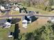 A high-angle aerial view of a house with a yard, fire pit and a neighborhood in a wooded area at 54 Silverleaf Dr, Wendell, NC 27591