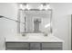 Bathroom with a large mirror, double vanity, modern lighting, and neutral tones creating a spa-like retreat at 54 Silverleaf Dr, Wendell, NC 27591