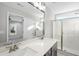 Bathroom featuring double vanity, modern fixtures, large mirror, and glass-enclosed shower at 54 Silverleaf Dr, Wendell, NC 27591