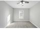 Bright bedroom featuring neutral walls, gray carpet, a window, and a ceiling fan with light fixture at 54 Silverleaf Dr, Wendell, NC 27591
