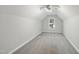 Finished bonus room with neutral carpet, a window for natural light, and ample space for various activities at 54 Silverleaf Dr, Wendell, NC 27591