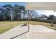 Comfortable covered patio with a stone fire pit and spacious backyard at 54 Silverleaf Dr, Wendell, NC 27591