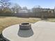 Close-up of the backyard's attractive stone fire pit on concrete patio at 54 Silverleaf Dr, Wendell, NC 27591