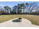 The backyard features a stone firepit with adjacent concrete patio and expansive lawn at 54 Silverleaf Dr, Wendell, NC 27591