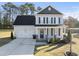 Inviting two-story home featuring a covered porch, well-kept lawn, and attached garage at 54 Silverleaf Dr, Wendell, NC 27591