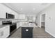 Spacious kitchen featuring white cabinets, stainless appliances, and a granite island with seating at 54 Silverleaf Dr, Wendell, NC 27591