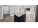 Modern kitchen island with granite countertop and stainless steel appliances in an open concept floor plan at 54 Silverleaf Dr, Wendell, NC 27591