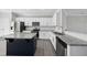 Eat-in kitchen with a large island, granite counters, stainless steel appliances and white cabinetry at 54 Silverleaf Dr, Wendell, NC 27591