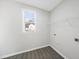 Laundry room featuring vinyl floors, a window, a wire shelf, and washer and dryer hookups at 54 Silverleaf Dr, Wendell, NC 27591