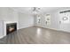 Sunlit living area showcasing a cozy fireplace, multiple windows, and a welcoming front door at 54 Silverleaf Dr, Wendell, NC 27591
