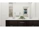 Modern bathroom with a dual sink vanity, dark cabinets, and a view of the shower at 5640 Cayden Cove Dr, Wendell, NC 27591