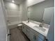 Bright bathroom with double vanity, white cabinets, and a shower-tub combination at 5640 Cayden Cove Dr, Wendell, NC 27591