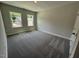 Cozy bedroom with plush carpet and two windows offering plenty of natural light at 5640 Cayden Cove Dr, Wendell, NC 27591