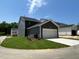 A view of the exterior of the house with green grass and a garage at 5640 Cayden Cove Dr, Wendell, NC 27591