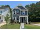 Beautiful two-story home featuring gray siding, a stone base, and a neatly manicured lawn at 5640 Cayden Cove Dr, Wendell, NC 27591